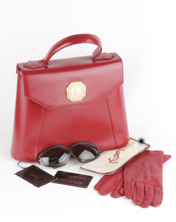 An Yves St. Laurent red leather handbag; together