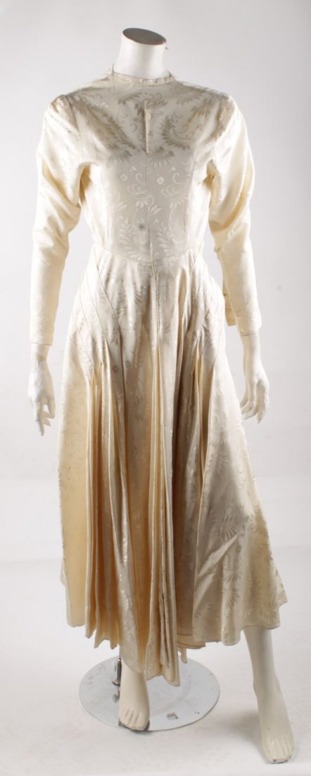 A 1950s cream brocade wedding dress; together wit