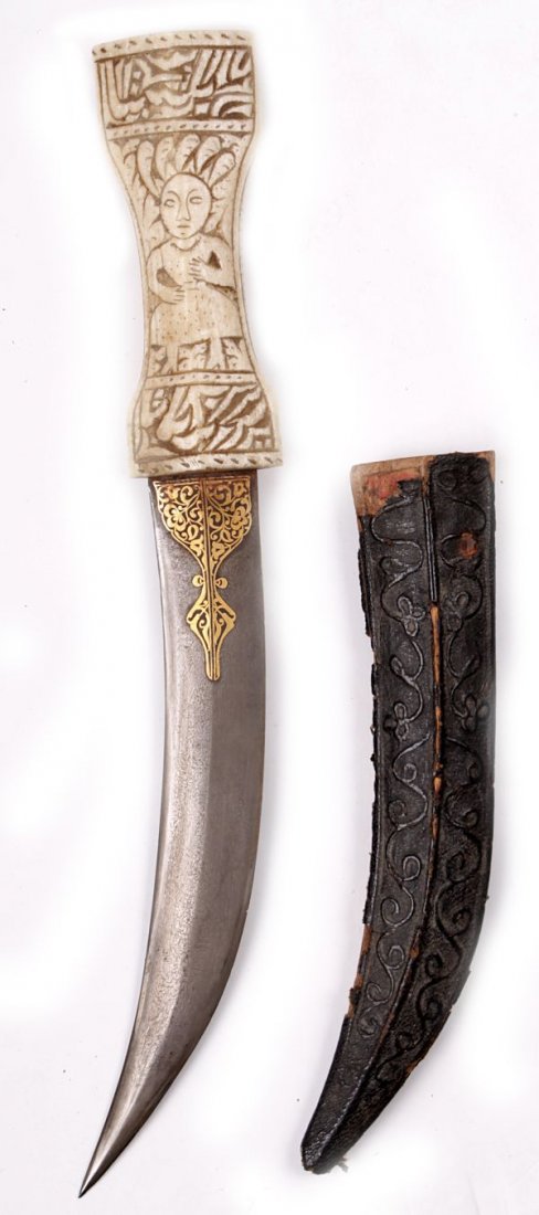 An Indo-Persian Dagger , with a curved 23cm damasc: An Indo-Persian Dagger, with a curved 23cm damascus double-edged blade, formed with a medial ridge, decorated with gold koftgari, on one face at the forte, carved ivory hilt, decorated with figures an