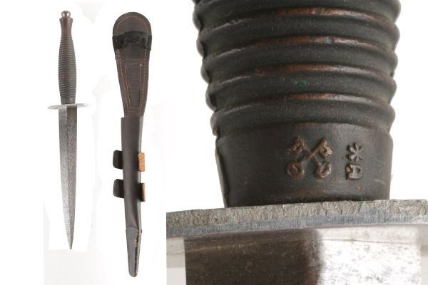 A Post-War F S Third Pattern Fighting Knife , stan: A Post-War F&S Third Pattern Fighting Knife, standard specification, with polished blade, straight cross-guard and ringed grip, in its brass mounted leather sheath with perforated wings.