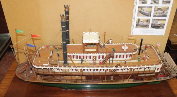 A model of the Mississippi paddle steamer the 'St.: A model of the Mississippi paddle steamer the 'St. Louis Belle', with detailed, populated deck areas, the superstructure removable for motorized operation, 100cm long, with a transportation case. 