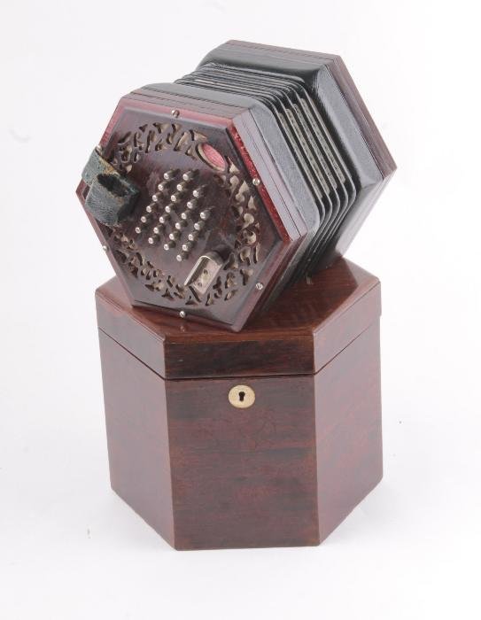 An R.J. Ward Son 48-key concertina, serial no.: An R.J. Ward & Son 48-key concertina, serial no. 27755, the octagonal rosewood fret-carved ends with leather thumb straps and nickel-plated finger rests, the five-fold leather bellows with printed
