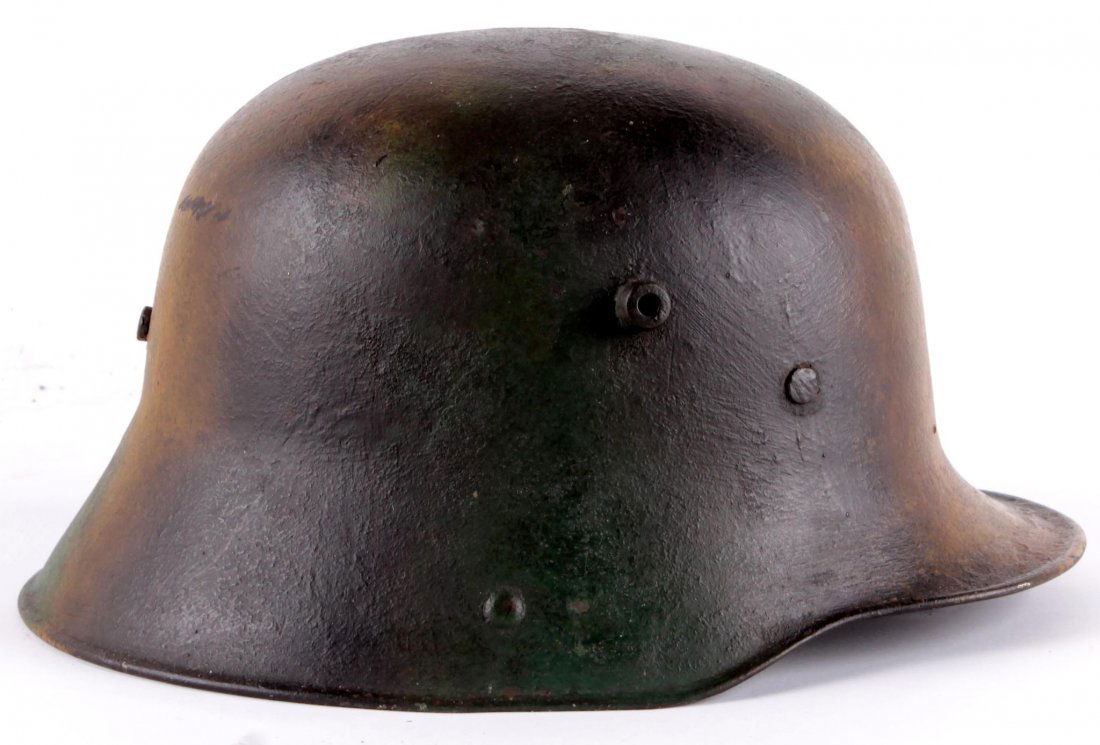 A Great War Imperial German M16 Steel Helmet with: A Great War Imperial German M16 Steel Helmet with post-war camo paint finish, complete with original liner.