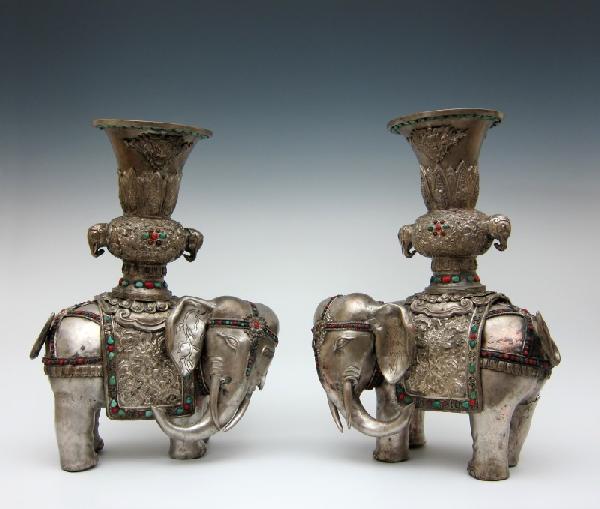 Pair of Tibetan Silver-Clad Altar Figures: Standing elephants surmounted with vases, each inlaid with semi-precious stones, including turquoise, lapis lazuli, jade, feldspar, malachite, and carnelian. Probably circa late 19th/early 20th centur