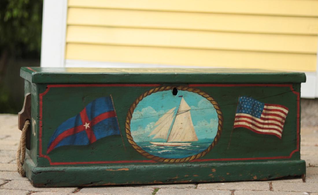 Authentic Sea Chest with painted decoration: America's Cup painted chest. Wood sea chest with later decoration showing a portrait of the America’s Cup yacht Defender along with the New York Yacht Club burgee and American flag. 37” x 15 1/2��