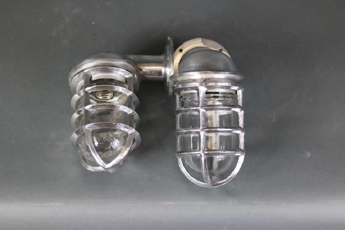 Ship Companionway Lights: Pair of aluminum ship companionway lights. Ninety degree design with removable protective cages, glass jars, a/c sock\ets.