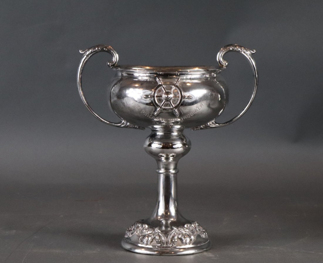1909 Philadelphia Endquirer yacht trophy: Silver plated loving cup yachting trophy with raised ships wheel. Bowl is engraved THE PHILADELPHIA INQUIRER REGATTA 1909. Bottom is marked Caldwell and Co, Philadelphia. Silver plated and number 1128