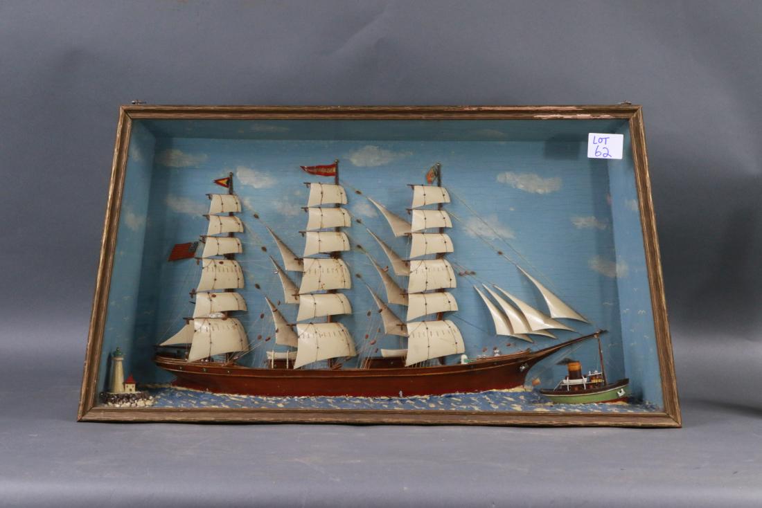 Shadow box of a British clipper ship: Full rigged English clipper ship set at its waterline onto a composite sea. Rigged with a suit of thirty sails. Pennants are flying. Lighthouse off the stern. 31 x 4 x 16