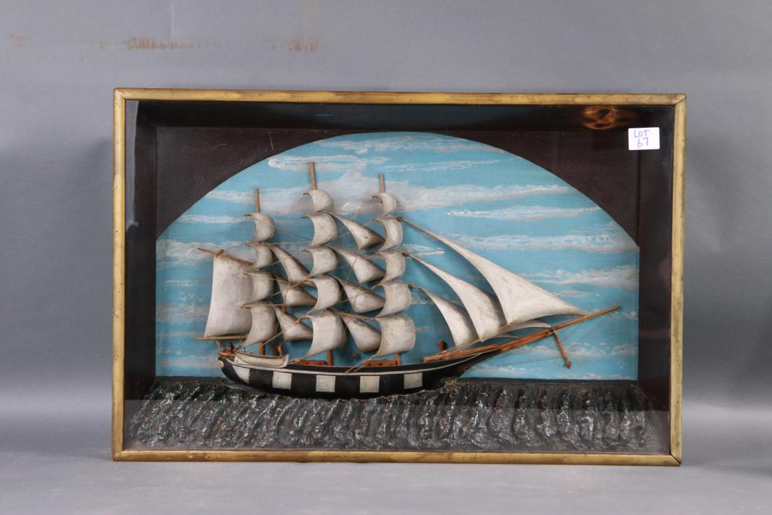 Primitive shadow box ship model: A full rigged bark ship model set into a carved sea. With painted background. Full suit of carved wood sails. 33 x 4 x 22