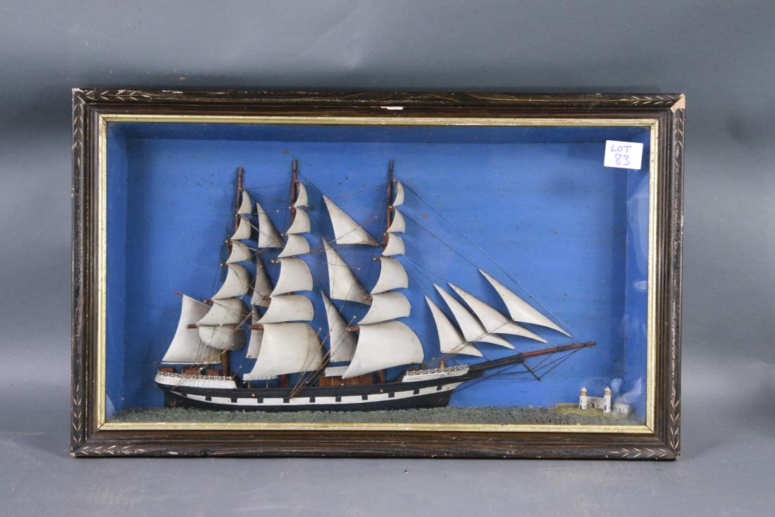 Antique packet ship diorama model: Detailed antique packet ship model with an incredible suit of twenty nine carved wood sails. The merchant ship hull is painted with a row of simulated gunports. A pair of lighthouses are seen off the