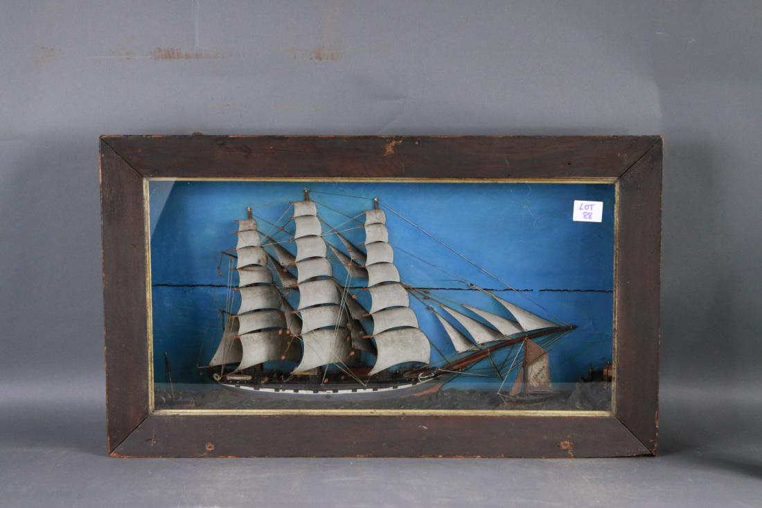 Detailed English shadowbox ship model: Finely crafted shadowbox ship model showing an English merchant ship with simulated gunport heading towards a harbor with LONDON PILOT BOAT NUMBER 2 of the starboard bow. A small paddle steamer is fou