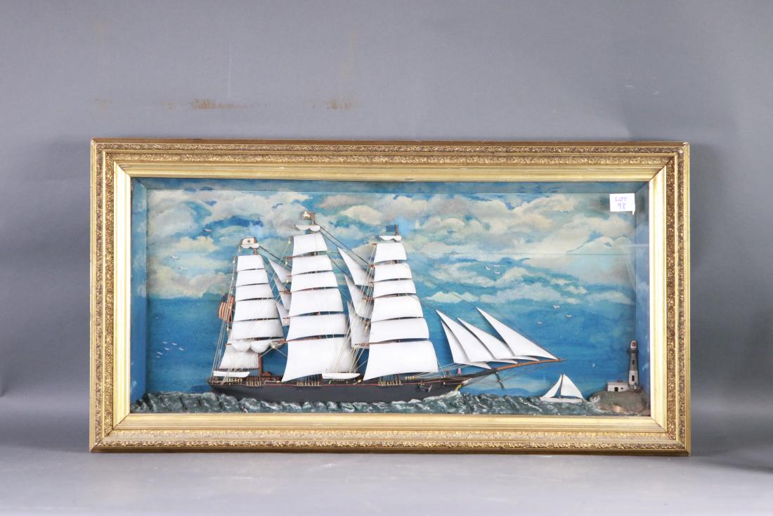 Shadowbox diorama with clipper ship: Maritime diorama showing an American clipper ship under full sail with painted sky, lighthouse and sloop. Wood and gesso frame. 43 wide x 23 tall, x 4 deep
