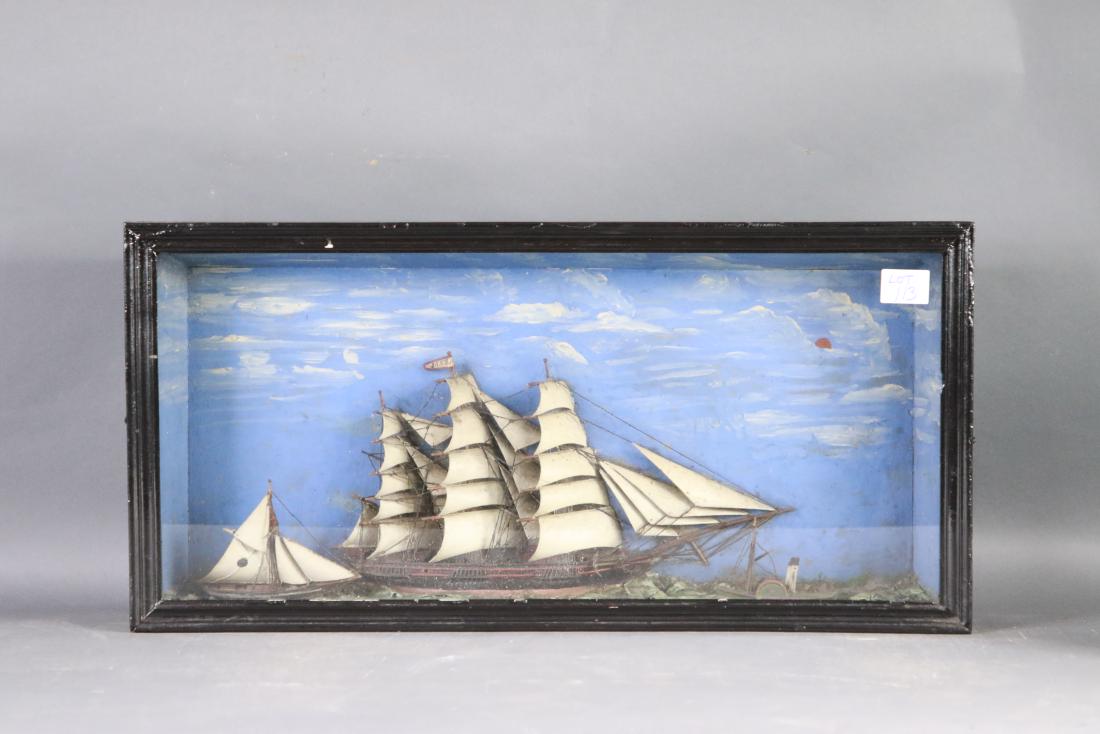 19th century ship shadowbox: Maritime shadowbox diorama showing a clipper ship under full sail with twenty two carved wood sails along with a pilot schooner crossing its stern. Set into a moulded sea. Back panel with cloud painte