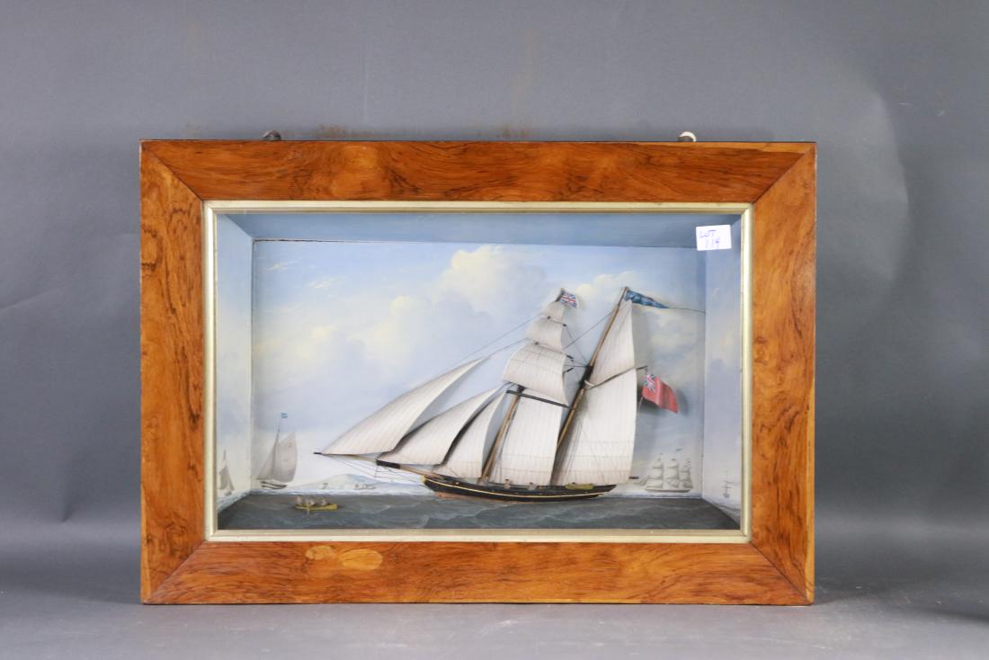 Superb English shadowbox ship model: Very fine model of an English topsail schooner with raked masts. With a suit of eight sails outlined with stitched seams in India Ink. Painted background with highly detailed painting of a clipper shi