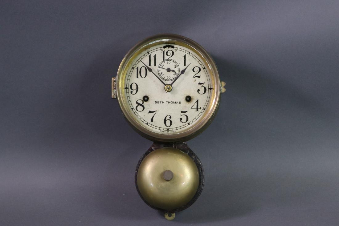 Brass Seth Thomas Clock: Brass Seth Thomas external bell ships clock on original wood backboard with second hand sweep. 6 inches face diameter x 10 inches tall