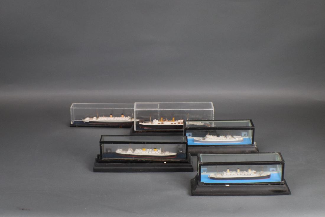 Basset Lowke Ship Model Lot: Group of 5 Basset Lowke waterline ship models in cases. Vessels include Dempo. Homeric, Columbus, Empress of Australia and Reliance. Longest is 9â€.