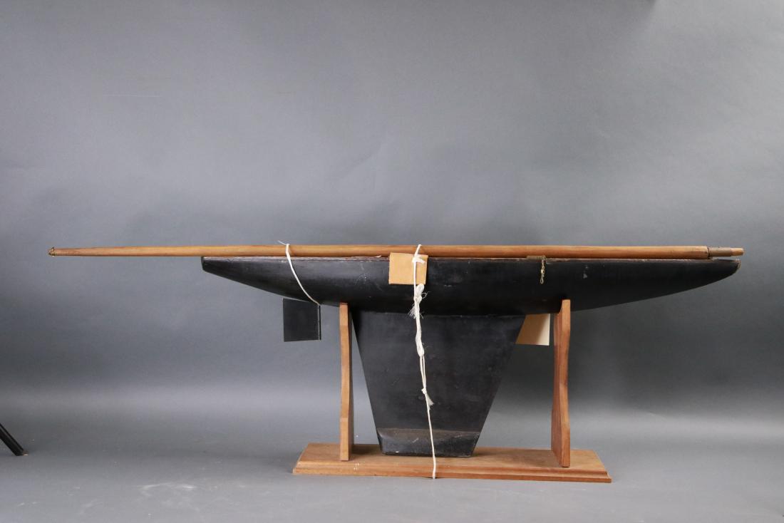 1930s vintage pond yacht: Nicely formed vintage pond yacht form the 1930s. Set on wood cradle. 36 inches long x 8 inches wide x 58 inches tall.