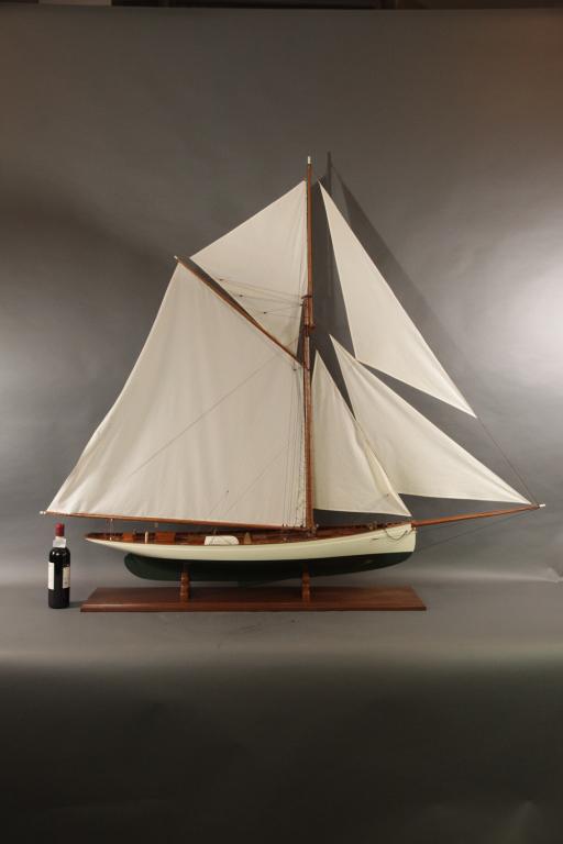 SIX FOOT MODEL OF CUP YACHT PURITAN 73L X 64T: Six foot model of the Boston built Americas Cup yacht Puritan. Fine model with planked deck, skylights with brass bars, suit of sails, etc.. mounted on a mahogany baseboard64H X 73L X 11W