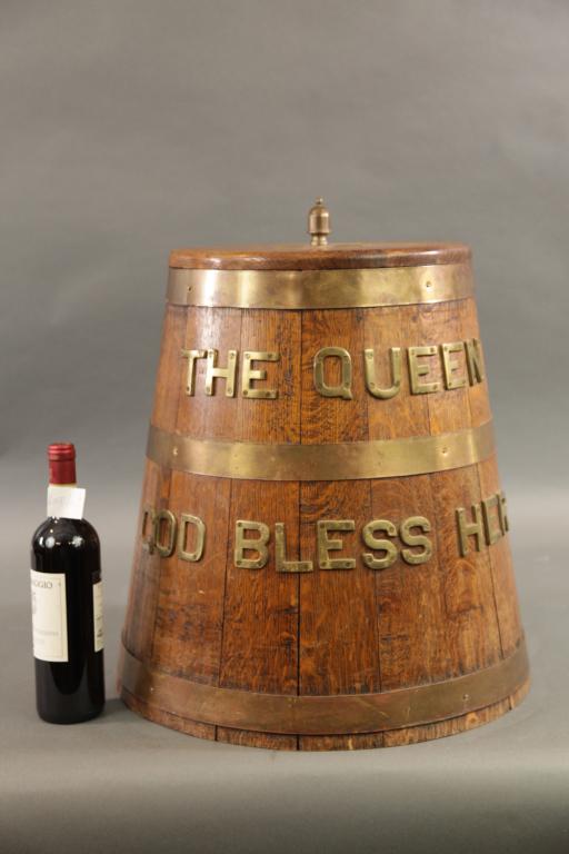 ROYAL NAVY GROG TUB THE QUEEN GOD BLESS HER: SOLID OAK GROG TUB WITH BRASS BANDS AND ' THE QUEEN GOD BLESS HER in brass letters.. Removable lid with brass knob.20H X 20L X 20W