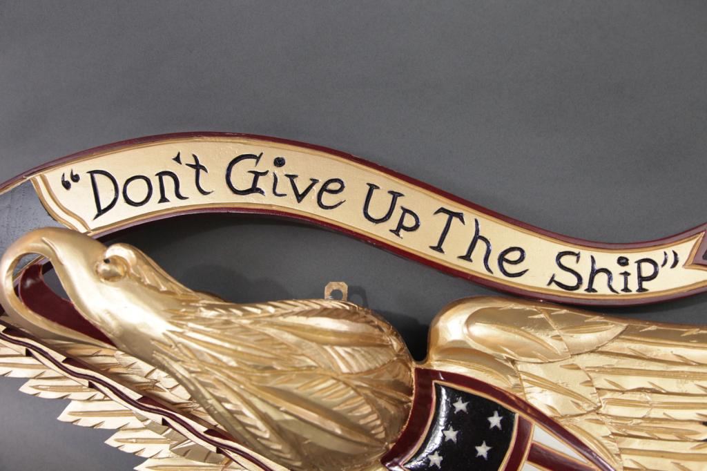 CARVED EAGLE DONT GIVE UP THE SHIP: Patriotic carved wood eagle with banner reading DONT GIVE UP THE SHIP. Painted gold. Nice carving work 11H X 30L
