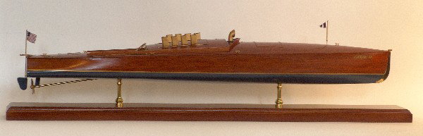 Speedboat Dixie II: Scale Model of the Competition Speedboat "Dixie II". Planked hull with exhaust cowls, controls, cleats, steering wheel, benches, ventilator cowl, and flagstaff with flag mounted in a mahogany display 