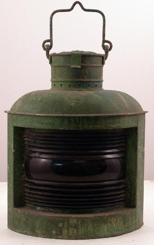Vintage starboard ship's lantern.: Early starboard ship's lantern in old green paint with maker's badge from A. Ward Hendrickson with carry handle and hinged top. Fitted with a green fresnel lens with a few small chips. 20" high withou
