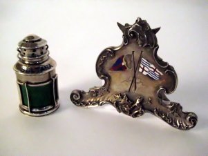 Sterling Items from Steam Yacht Sultana: "Sterling place card holder and salt shaker with New York Yacht club burgees and the John Drexel's private signal flags. The salt shaker is marked ""Sterling, Black Starr & Frost"" with eagle hallmark