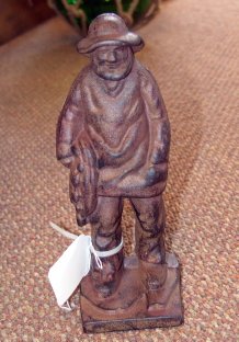 Salty Fisherman Doorstop or Shelf Decoration: "Salty fisherman doorstop or shelf decoration of cast iron. 11"" tall."