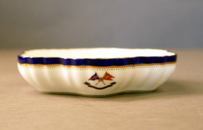 Scalloped Candy dish from Corsair: Candy dish from Corsair by Mintons, 5 3/4". The Mintons china has the J. Pierpont Morgan signature navy blue trim with gold accents. top inside edge of the plate has the New York Yacht Club burgee and