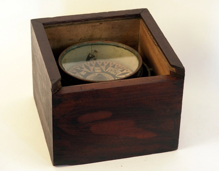 Mid 19th century ship's compass: Mid 19th century brass ship's compass. Compass card with maker's name D. McGregor & Co., Glasgow & Greenock. Mounted with gimbals into a thick timber box. 6 1/2" compass diameter. Box is 10" x 10" x 8