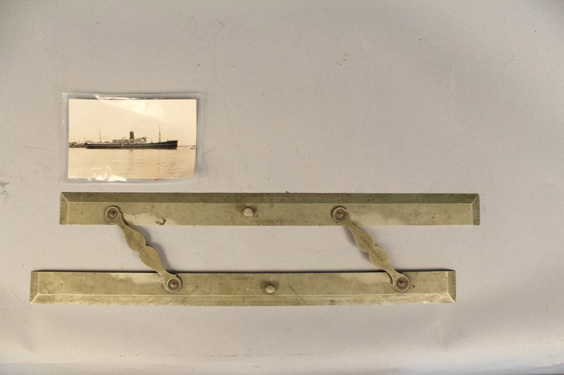 Metal parallel ruler - S.S. Mongolia: Parallel ruler for navigation, plotting course or direction. Manufactured by D. McLean & Co. Ltd. London for S. S. Mongolia. Included with this lot is a postcard of S. S. Mongolia. Rule is 18" long x 