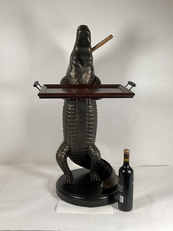 Carved Wood Alligator Holding a Tray: Carved wood alligator with cigar in his mouth and holding a tray. Mounted to a thick wood base with routed edge. Great Accent Piece. Barware Uses, hall table, key stand, night stand, occasional table.