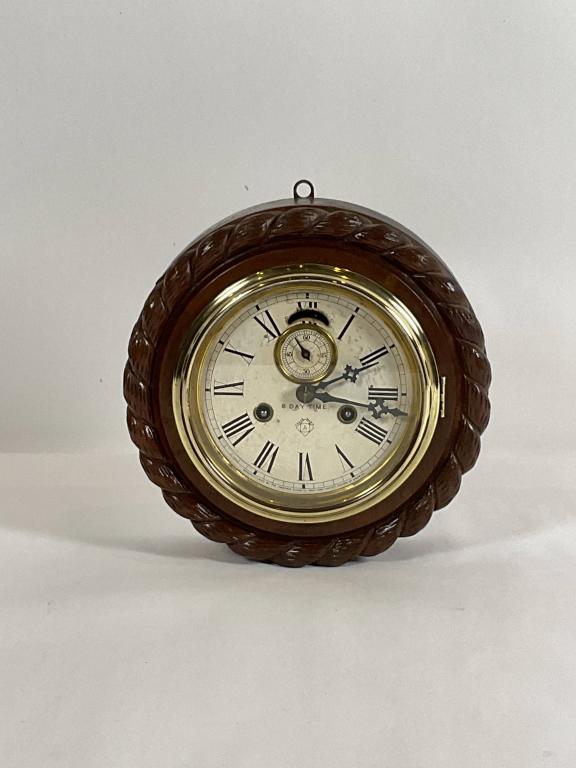 8 Day Ships Clock by Ansonia Clock Co: Ships clock in carved oak case with rope border. Label on back reads "Eight day, Lever, Ansonia clock company", Manufacturers of a Variety of one and eight day etc. Circa 1920. Dimension: 3" H x 10"L
