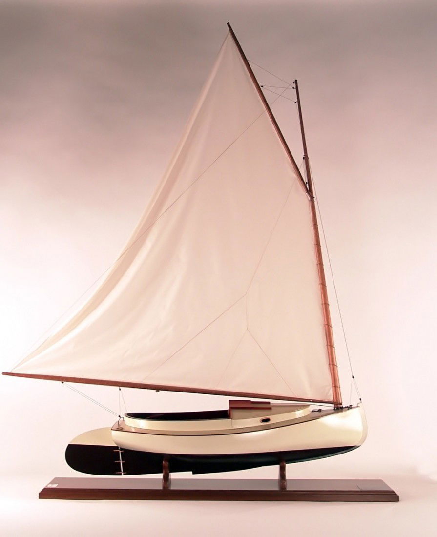 6 foot model of a Crosby Cat Boat: Scale model of the cat boat "Moonlight". Finely crafted model of the Crosby cat boat "Moonlight" with carved hull, mahogany cockpit and cabin detail. Rigged with a large linen sail. 52” long x 16”