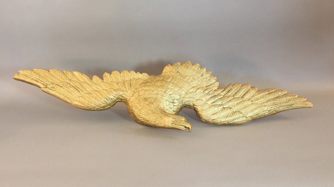 Kenneth Lynch Cast Metal Eagle.: A gold painted cast metal eagle by Kenneth Lynch of Wilton, Connecticut. Know as the "Wilton" model, this highly detailed piece was recommended for use over a doorway. 10 1/2" tall x 44 1/2" wide.