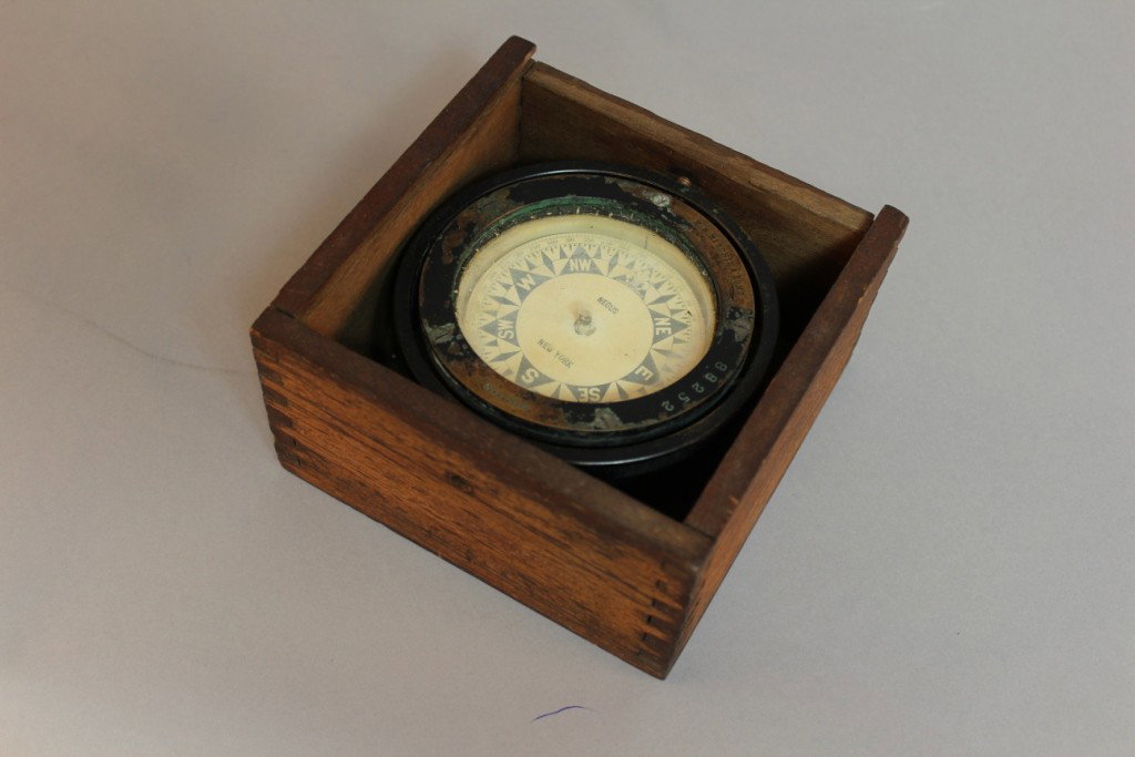 E.S. Ritchie boat compass in box.: Small boxed boat compass, brass bezel with maker's name E.S. Ritchie, Boston. The compass card is marked with the ship chandler's name "Negus" of New York. Fitted to a dovertailed timber box with slid
