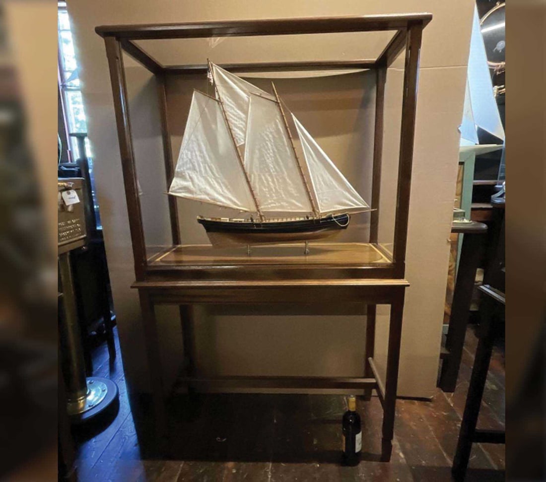 Virginia Pilot Schooner Katy In Case: Cased model of the pilot schooner Katy. Details include planked deck, hawse pipes, anchors, cleats, tiller, stove pipe and other details. Rigged with a full suit of sails and standing and running cord