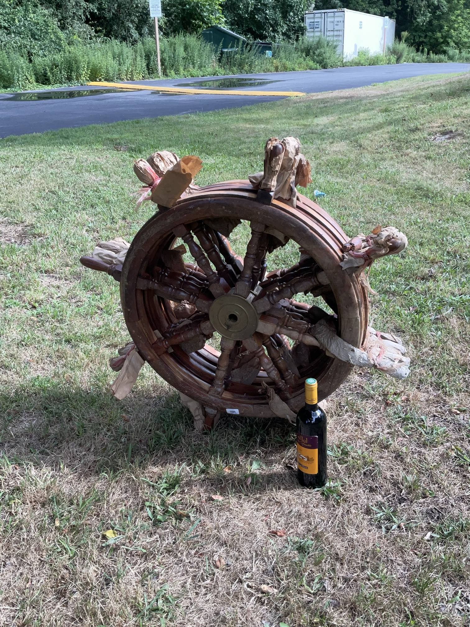 Five Ships Wheels as a Lot from Pier 4 (5 pcs): Group of five reproduction ships wheels as a lot. Five teak ships wheels with brass hubs, one with broken spoke. Found in the Anthony's Pier 4 Restaurant warehouse. Weathered condition. 36" Diameter.