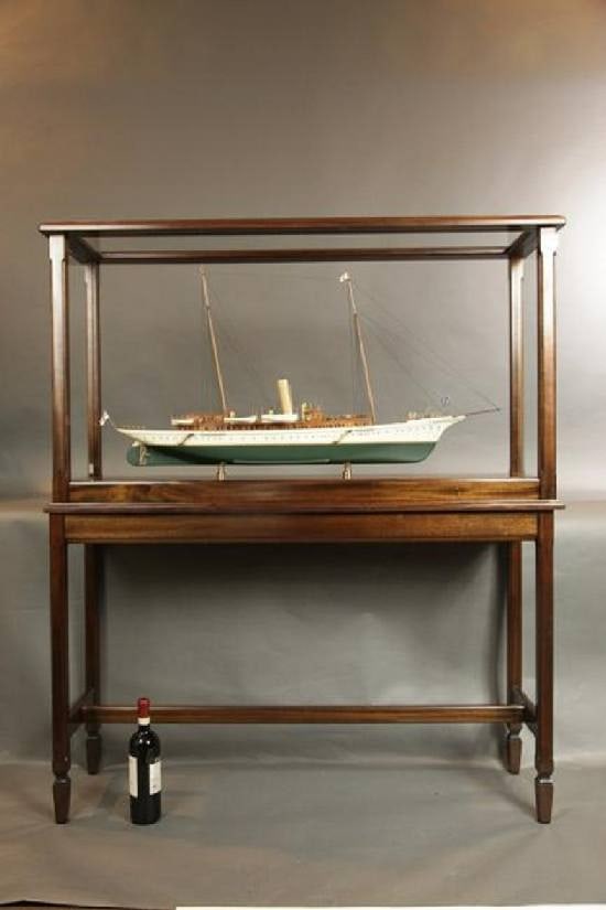 Steam Yacht "Erin": Exhibition quality model of Sir Thomas Lipton's private yacht, "Erin". Mahogany cabins, planked deck, six lifeboats, railings, skylights, funnels, etc. Mounted into a mahogany display case with table.