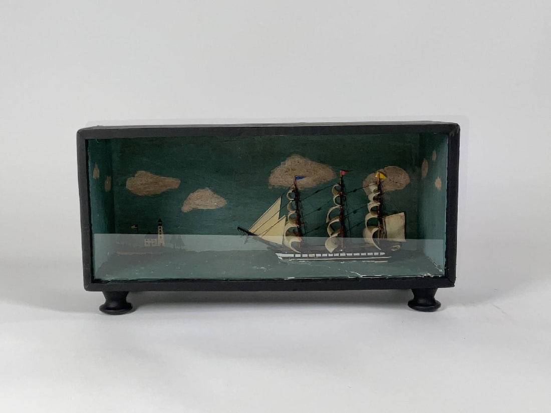 Ship Model Diorama of a Full Rigged Warship: Nautical diorama of a square rigged warship under full sail. Set at its waterline in a calm sea with a painted background with lighthouse and clouds. 6" H x 4" W x 11" L. 3 lbs.
