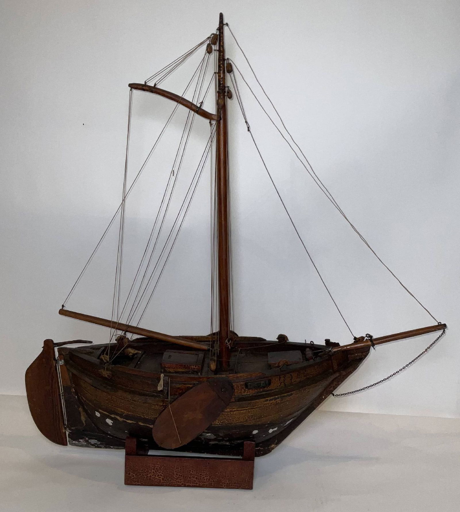 Cargo Vessel of a Dutch Leeboards: Antique boat model with an open deck design. The hull is bulbous and double-ended with leeboards, hatches, etc. Nicely rigged, rigging is in good order. Fitted to a cradle. 16 lbs. 33"H x 31"W x 11"D.