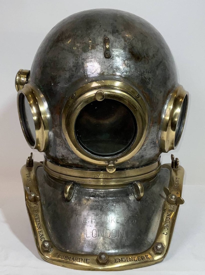 Deep Sea Diving Helmet of a C.E.Heinke style: Very authentic appearing recreation of a deep-sea hard hat diving helmet of a C.E. Heinke model. The copper bonnet and breastplate have been tinned. The brass brails are engraved C.E. Heinke & Co., Su