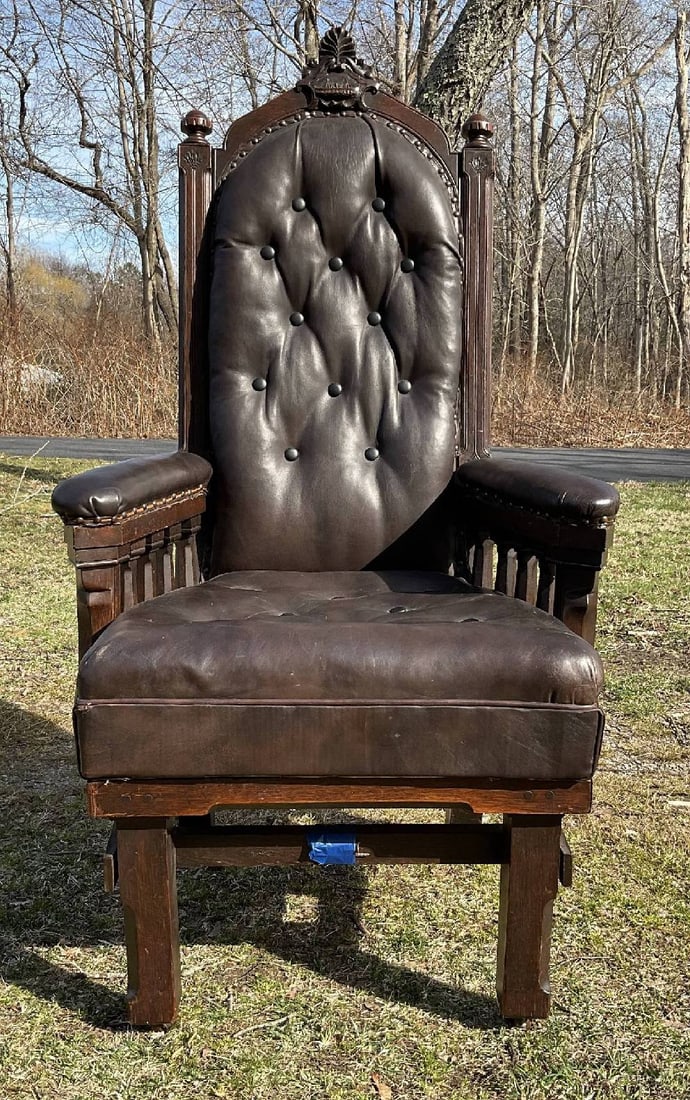 Mid-19th Century Sea Captain's Chair: Fabulous heavily carved leather and wood chair with ship in relief at the crown of the seat back, with heavily padded seat back and cushion. Seat back has buttons. Very sturdy frame. 56"H x 29"W x 25"