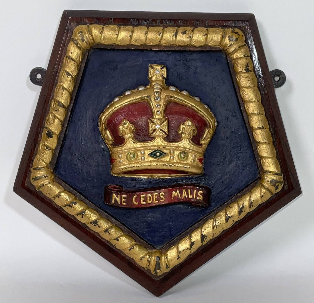 Royal Navy Badge Representing Royal Navy Police and Regulating Branch: Brass Royal Navy badge with painted and gilded finish. Showing a royal crown on a pentagon shaped badge that is mounted to wood. 10 lbs. 10" H x 10" W.