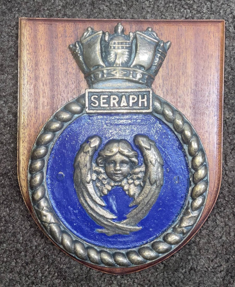 Ships Badge from HMS Seraph: Solid brass ships badge from the British Royal Navy Seraph. 6 lbs. 10" H x 8" W.