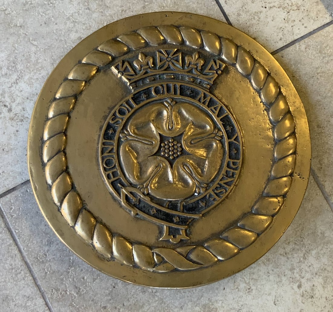 Gun Tompion from the Royal Navy Warship H.M.S. Duke of York: Heavy brass gun tompion from H.M.S. Duke of York with the Latin phrase Honi Soit Qui Mal Y Pense on an Order of the Garter belt with buckle and crown. 24" Diameter.