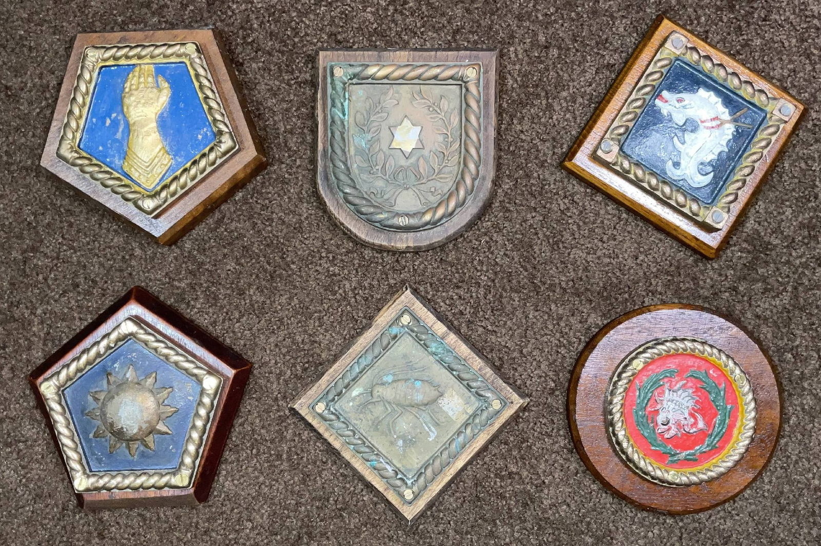 Chatham Dockyard Ship's Badges in Pentagonal, Badge, Diamond, and Circular Form: Group of six Royal Navy badges from HMS Champion, HMS Valhalla, HMS Franklin, HMS Apollo, HMS Aphis, and HMS Ainste. All are from World War I or World War II and are mounted to wood backboards. 17 lbs