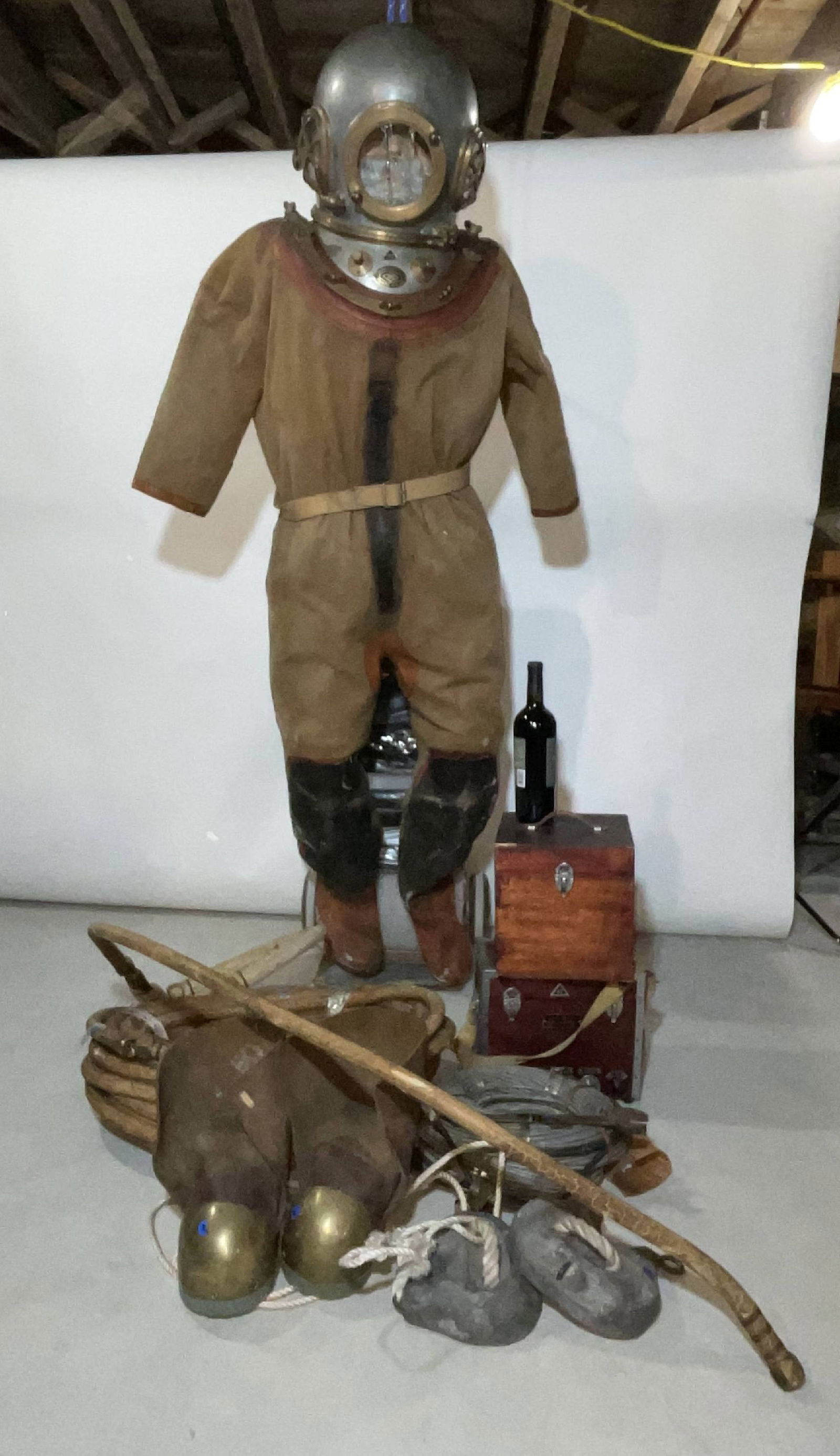 Diving Helmet with Suit and Boots and Radio Unit Etc: Deep sea diver's helmet with suit, radio, hose, boots, weights, etc. Helmet has a badge from "TOA Diving Apparatus Co. Ltd., Minamisenji, Tokyo, Japan." Large pair of breast weights and brass-soled