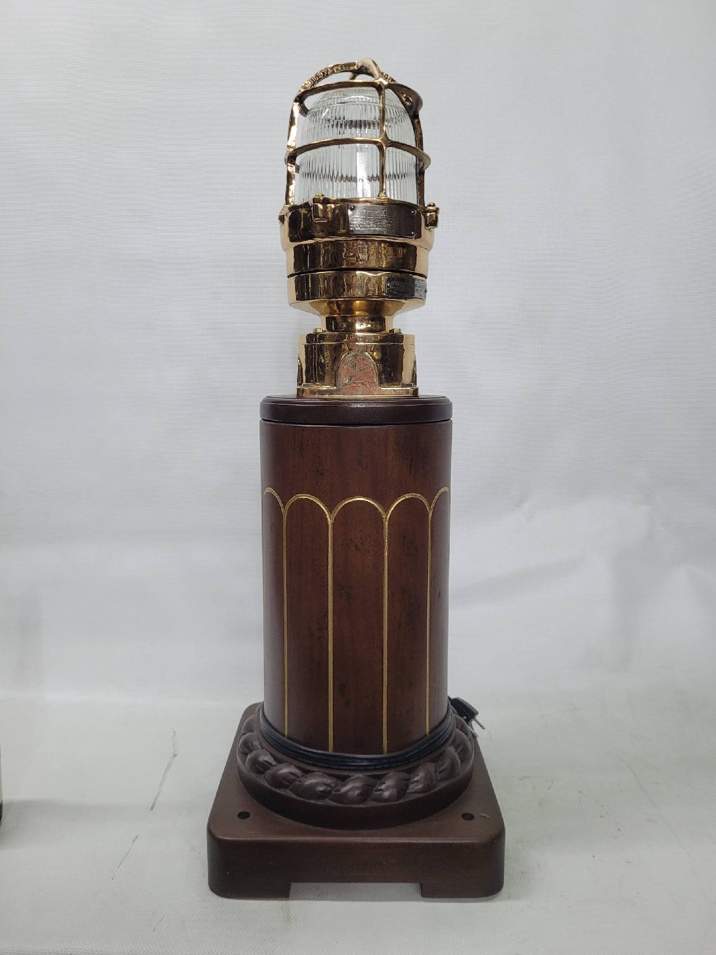 Solid Brass Marine Beacon on Wood Base: Solid brass beacon with Fresnel lens, brass cage, ac socket. Polished and lacquered.