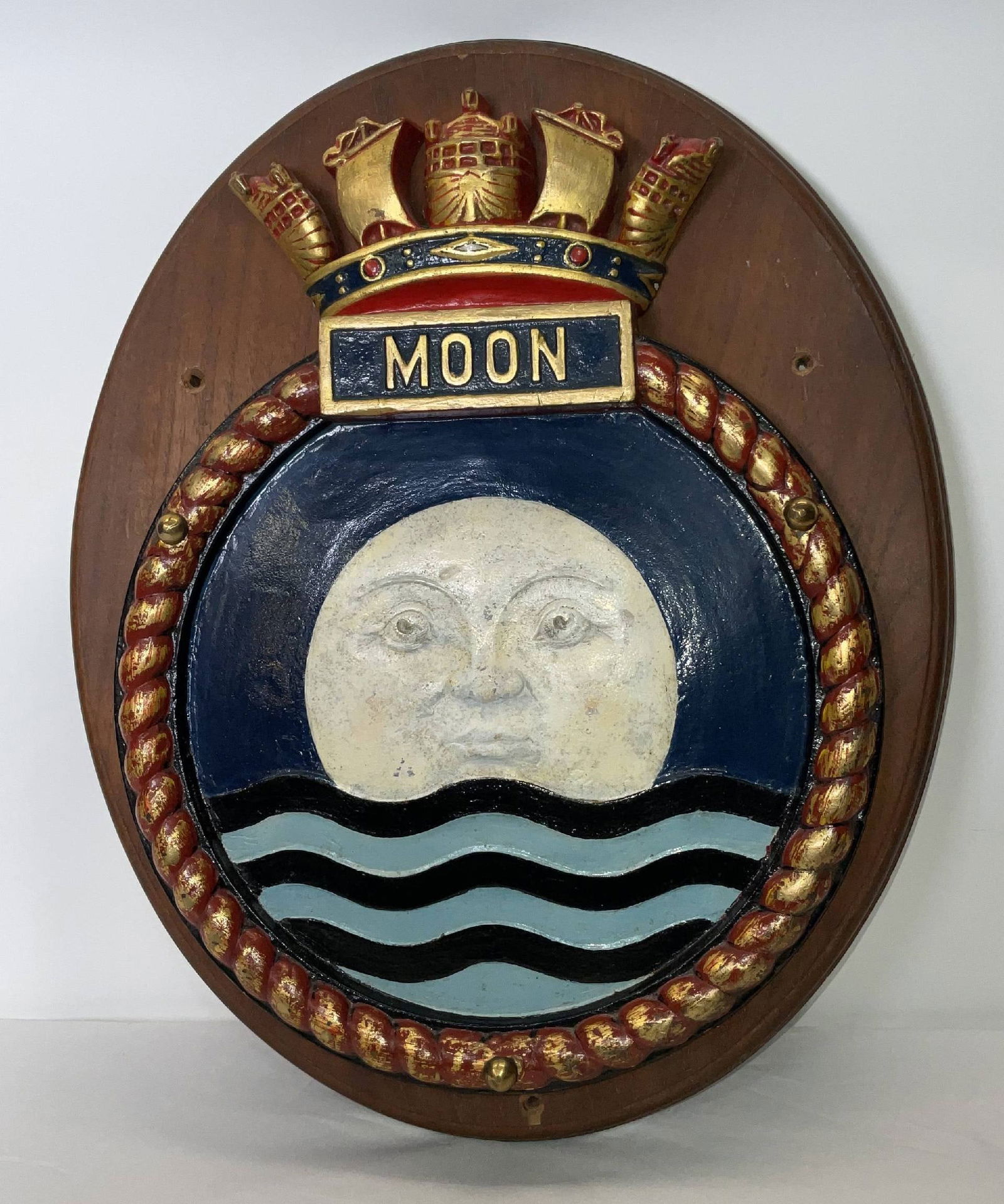 HMS Moon Screen Badge from the British Royal Navy: Large ship's badge from HMS Moon, an Algerine-class minesweeper from World War II. Nice design with a moon settling into the waves. Wood backboard. 38 lbs. 21"H x 17"W.
